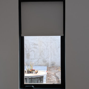 Cordless Blackout Roller Shade under Black Metal Fascia