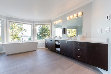 This is an example of a large transitional master bathroom in Other with flat-panel cabinets, dark wood cabinets, a freestanding tub, grey walls, porcelain floors, an undermount sink, engineered quartz benchtops and white benchtops.