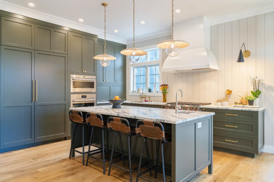 Eat-in kitchen - mid-sized transitional l-shaped light wood floor and brown floor eat-in kitchen idea in New York with shaker cabinets, gray cabinets, marble countertops, white backsplash, shiplap backsplash, stainless steel appliances, an island and multicolored countertops