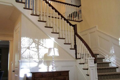 Example of a mid-sized classic dark wood floor and brown floor foyer design in New York with beige walls