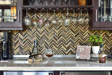 Inspiration for a large transitional travertine floor kitchen pantry remodel in Phoenix with a double-bowl sink, shaker cabinets, dark wood cabinets, solid surface countertops, stainless steel appliances and an island