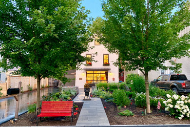Photo of a contemporary front yard concrete paver walkway in Portland Maine.