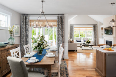 Example of a transitional medium tone wood floor and brown floor great room design in Boston with beige walls