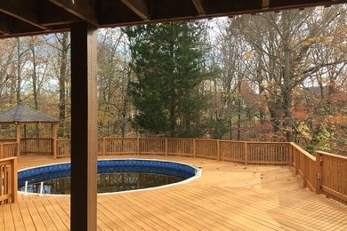 Example of a huge arts and crafts backyard deck design in Louisville with no cover