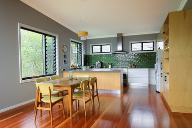 This is an example of a mid-sized contemporary kitchen/dining combo in Newcastle - Maitland with grey walls, medium hardwood floors and brown floor.