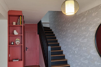 Imagen de escalera actual con escalones de madera, contrahuellas de madera, barandilla de madera y papel pintado