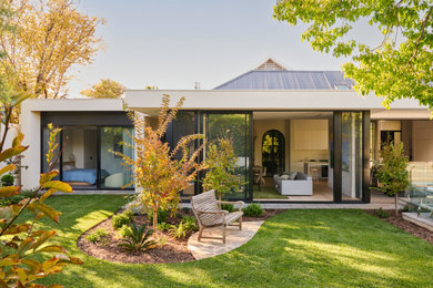 Design ideas for a contemporary one-storey house exterior in Adelaide with a flat roof, a metal roof and a grey roof.