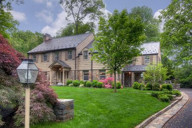 Example of a large classic beige two-story mixed siding house exterior design in New York with a shed roof and a shingle roof