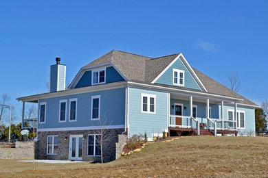 Inspiration for a mid-sized transitional blue two-story wood house exterior remodel in Louisville with a clipped gable roof and a shingle roof