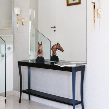 Neoclassical Entrance Hall with Console Table and Brass Sconces