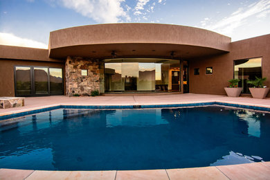 Example of a large southwest backyard tile and rectangular lap hot tub design in Salt Lake City