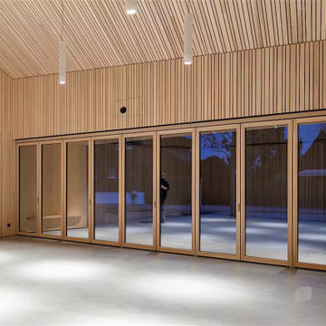 Wood-Lined Living Room with a Full NW Wood 540 Glass Wall, Berneck Residence