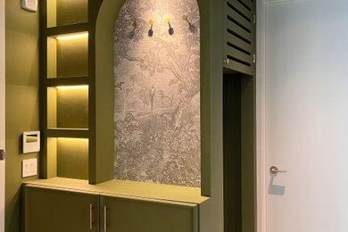 Entryway - small french country light wood floor, beige floor and wallpaper entryway idea in New York with green walls and a white front door