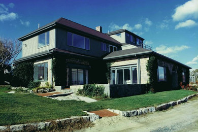 Photo of a large transitional three-storey exterior in Boston with stone veneer and a hip roof.