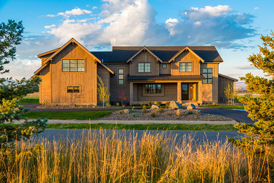 Inspiration for a large rustic brown three-story wood gable roof remodel in Other