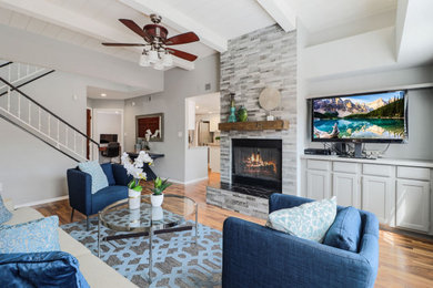 Living room - enclosed light wood floor and brown floor living room idea in Phoenix with a standard fireplace, a tile fireplace and a tv stand