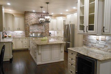 Large elegant u-shaped dark wood floor eat-in kitchen photo in Other with a farmhouse sink, raised-panel cabinets, white cabinets, granite countertops, beige backsplash, stone tile backsplash, stainless steel appliances and an island