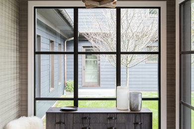 Trendy gray floor entryway photo in New York with brown walls