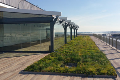Patio - large modern patio idea in Other with decking and a roof extension