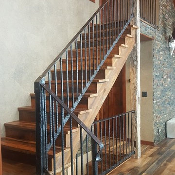 Reclaimed Wood Stair Treads and iron Railing in Rustic Mountain Home