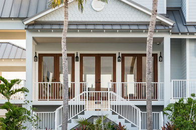 Inspiration for a large beach style two-storey exterior in Miami.