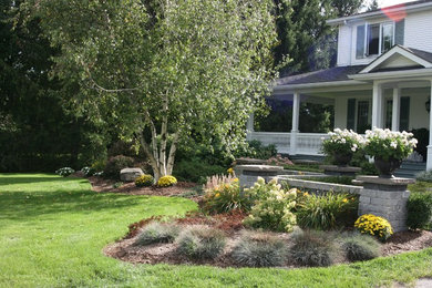 This is an example of a large traditional front yard stone landscaping in Toronto.