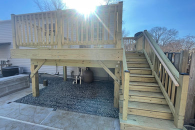 Mid-sized elegant backyard ground level wood railing deck photo in DC Metro with no cover