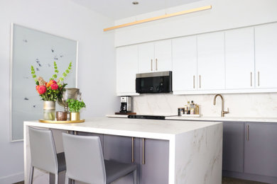 Kitchen - mid-sized transitional l-shaped concrete floor and gray floor kitchen idea in Toronto with a double-bowl sink, flat-panel cabinets, beige backsplash, stainless steel appliances, an island and beige countertops