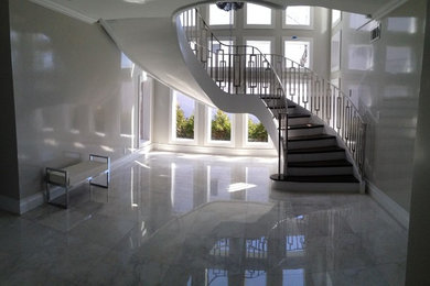 Staircase - mid-sized contemporary wooden curved staircase idea in New York with painted risers