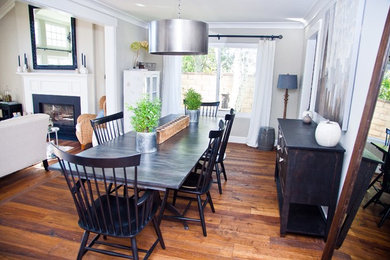 Inspiration for a mid-sized transitional open plan dining in Los Angeles with grey walls, medium hardwood floors, no fireplace and brown floor.