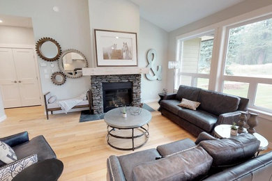 Inspiration for a mid-sized transitional open concept light wood floor living room remodel in Calgary with gray walls, a standard fireplace and a stone fireplace