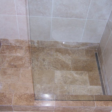 Travertine and porcelain shower with linear drain (after glass installation)