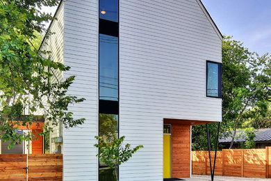 Example of a mid-sized minimalist white two-story concrete fiberboard exterior home design with a shingle roof