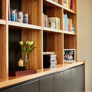 This is an example of a medium sized modern study in Sydney with grey walls, limestone flooring and a freestanding desk.