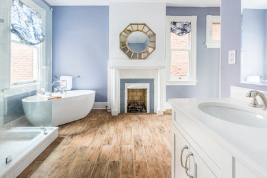 Freestanding bathtub - mid-sized transitional master white tile and ceramic tile ceramic tile and brown floor freestanding bathtub idea in Richmond with shaker cabinets, white cabinets, a two-piece toilet, gray walls, an undermount sink, quartz countertops and a hinged shower door