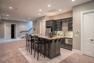 Basement - large contemporary underground carpeted and beige floor basement idea in Other with beige walls