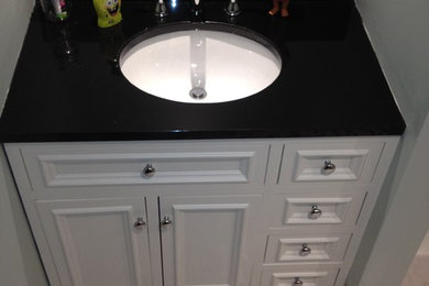 Inspiration for a small country kids' black and white tile and ceramic tile bathroom remodel in Boston with raised-panel cabinets, white cabinets, an undermount sink and granite countertops