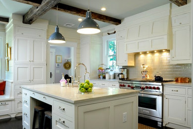 Inspiration for a transitional kitchen remodel in New York with white cabinets, quartzite countertops, ceramic backsplash, stainless steel appliances and a farmhouse sink