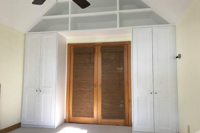Inspiration for a large tropical master carpeted and beige floor bedroom remodel in Charleston with beige walls and no fireplace