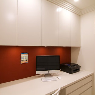 This is an example of a small modern study in Sydney with beige walls, porcelain flooring, no fireplace and a built-in desk.