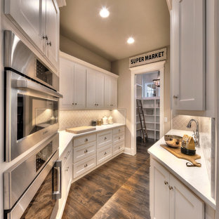 Huge kitchen pantry ideas - Kitchen pantry - huge dark wood floor kitchen pantry idea in Kansas City with white cabinets and quartzite countertops