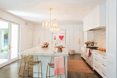 Large transitional l-shaped medium tone wood floor and brown floor open concept kitchen photo in Other with a farmhouse sink, recessed-panel cabinets, white cabinets, quartzite countertops, white backsplash, stone slab backsplash, paneled appliances and an island