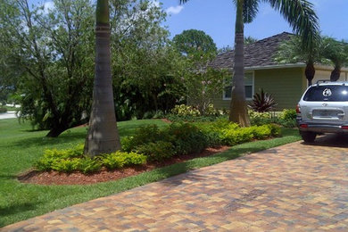 This is an example of a large tropical full sun front yard stone landscaping in Miami for summer.