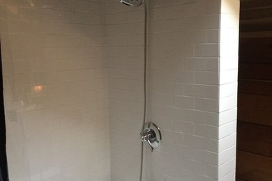 Example of a mountain style white tile and subway tile drop-in bathtub design in Other