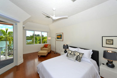Inspiration for a mid-sized transitional guest dark wood floor and brown floor bedroom remodel in Tampa with white walls and no fireplace