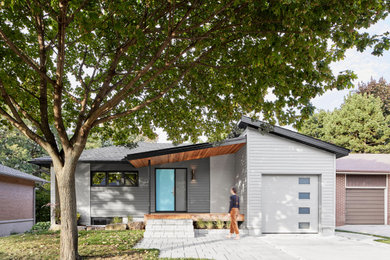 1950s gray one-story house exterior idea in Toronto with a shingle roof and a gray roof