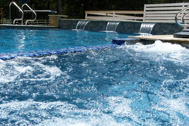 Example of a large minimalist side yard concrete and rectangular hot tub design in Houston