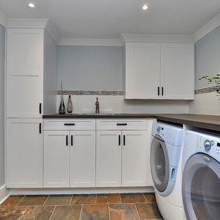 This is an example of a small classic look-out basement in Ottawa with blue walls and slate flooring.