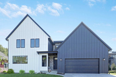 Modern black two-story exterior home idea in Minneapolis with a shingle roof and a black roof