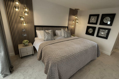 Photo of a scandinavian grey and white bedroom in Other with beige walls, carpet and beige floors.